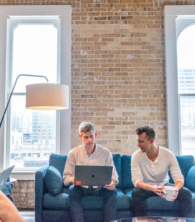 Two men in a meeting with a laptop