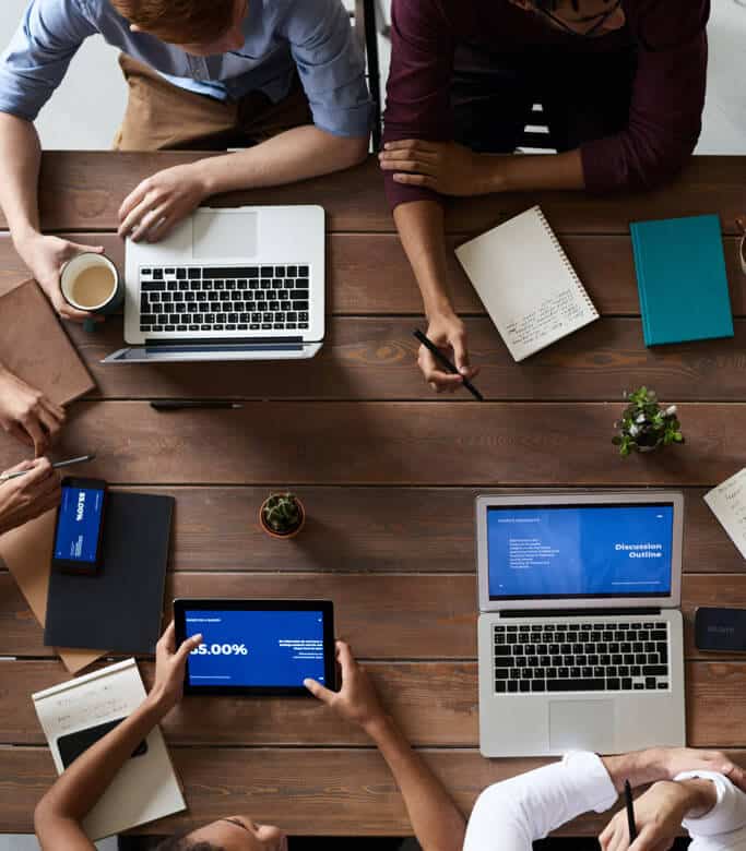 Overhead view of work meeting with people working around a table