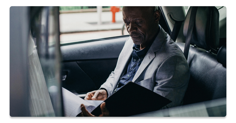 Business Owner looking through documents in car